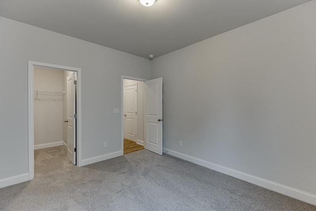 223 Montview Dr, Jefferson, GA 30549 - unfurnished bedroom featuring a walk in closet, carpet flooring, baseboards, and a closet