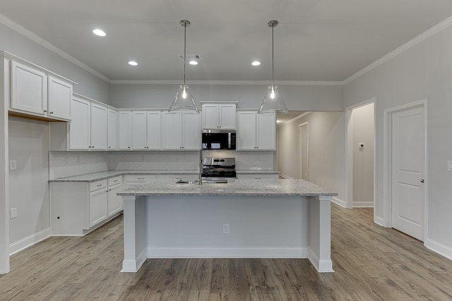 223 Montview Dr, Jefferson, GA 30549 - kitchen with an island with sink, backsplash, stainless steel range, and white cabinets