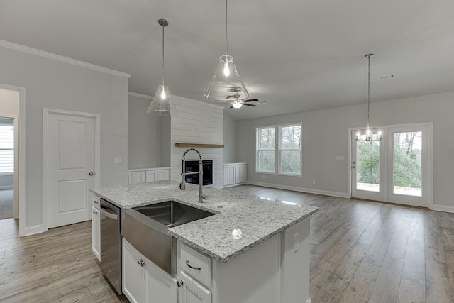 223 Montview Dr, Jefferson, GA 30549 - kitchen with stainless steel dishwasher, light wood-style flooring, baseboards, and a sink