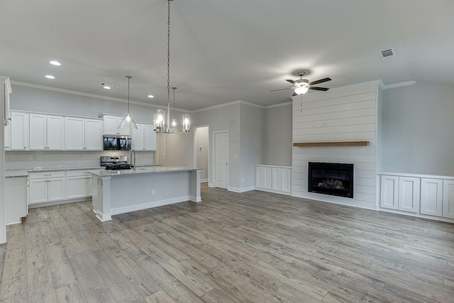 223 Montview Dr, Jefferson, GA 30549 - kitchen with recessed lighting, visible vents, stainless steel range oven, crown molding, and light wood-style floors