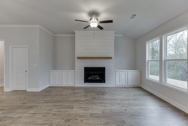 223 Montview Dr, Jefferson, GA 30549 - unfurnished living room featuring a ceiling fan, baseboards, visible vents, wood finished floors, and a large fireplace
