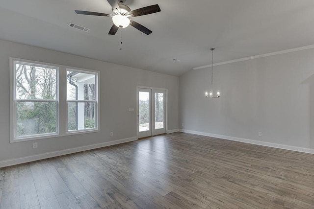 223 Montview Dr, Jefferson, GA 30549 - empty room with lofted ceiling, wood finished floors, visible vents, and ceiling fan with notable chandelier