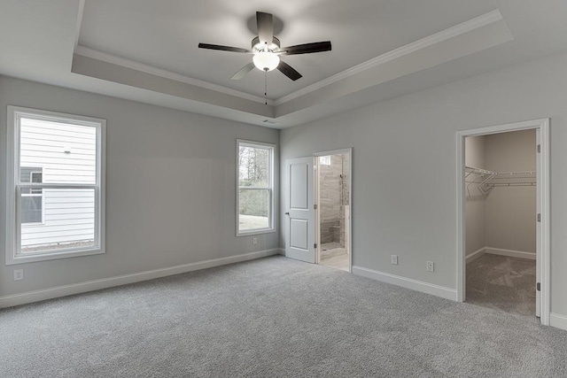 223 Montview Dr, Jefferson, GA 30549 - unfurnished bedroom featuring carpet flooring, a tray ceiling, crown molding, and a walk in closet