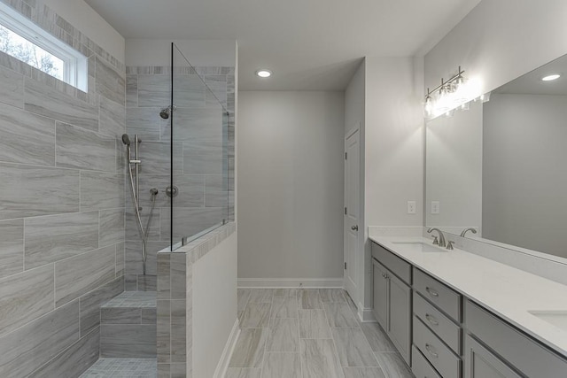223 Montview Dr, Jefferson, GA 30549 - full bathroom with double vanity, a tile shower, a sink, baseboards, and recessed lighting