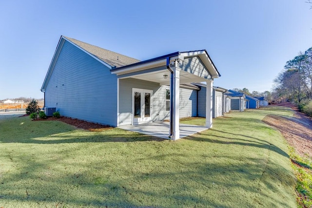 223 Montview Dr, Jefferson, GA 30549 - view of side of property featuring a yard, a patio area, french doors, and central AC