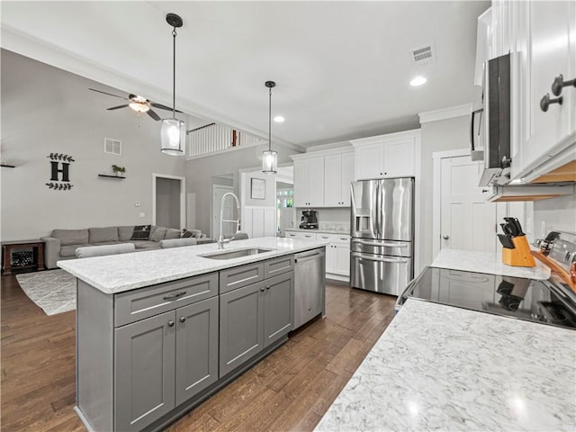 224 Blackthorn Rd, Colbert, GA 30628 - kitchen with appliances with stainless steel finishes, gray cabinets, white cabinetry, a ceiling fan, and an island with sink