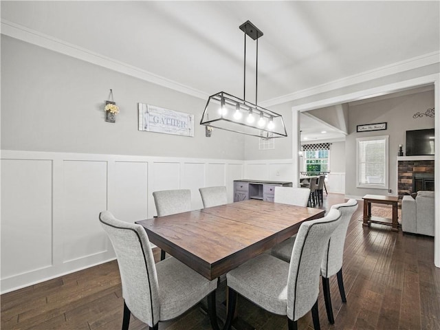 224 Blackthorn Rd, Colbert, GA 30628 - dining area with a decorative wall, ornamental molding, dark wood-type flooring, and wainscoting