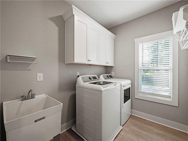 224 Blackthorn Rd, Colbert, GA 30628 - laundry room with separate washer and dryer, cabinet space, and light wood finished floors
