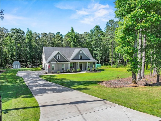 224 Blackthorn Rd, Colbert, GA 30628 - craftsman-style house with board and batten siding, a shed, concrete driveway, a front yard, and covered porch