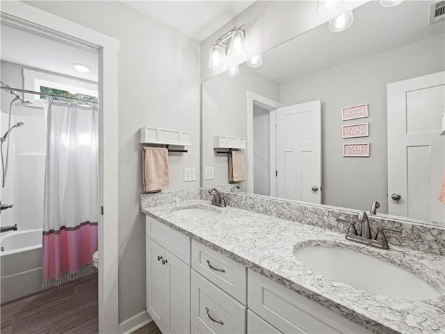 224 Blackthorn Rd, Colbert, GA 30628 - full bathroom featuring double vanity, shower / bath combo, and wood finished floors