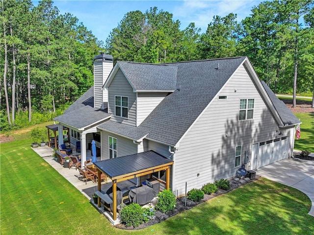 224 Blackthorn Rd, Colbert, GA 30628 - view of side of home featuring roof with shingles, a garage, a yard, concrete driveway, and a patio area