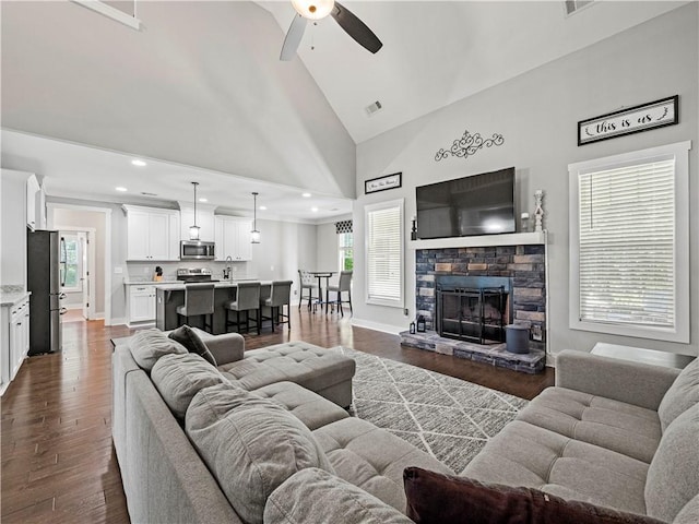224 Blackthorn Rd, Colbert, GA 30628 - living area featuring ceiling fan, high vaulted ceiling, dark wood-style flooring, a stone fireplace, and recessed lighting