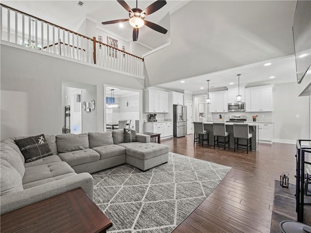 224 Blackthorn Rd, Colbert, GA 30628 - living area featuring a towering ceiling, a ceiling fan, dark wood finished floors, crown molding, and recessed lighting