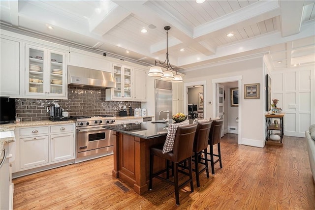 1634 Lenox Rd NE, Atlanta, GA 30306 - kitchen featuring tasteful backsplash, high end appliances, beamed ceiling, light wood finished floors, and range hood