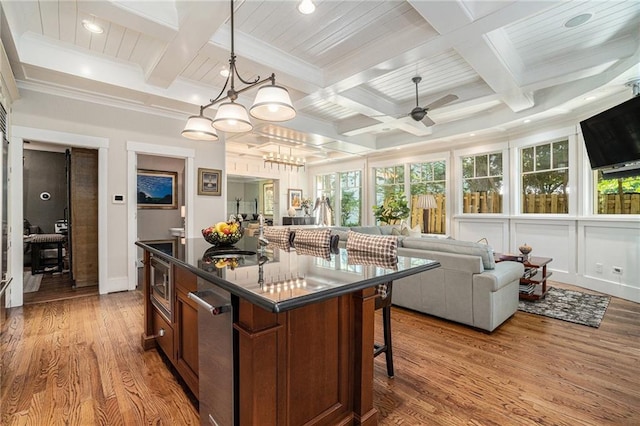 1634 Lenox Rd NE, Atlanta, GA 30306 - kitchen featuring ornamental molding, stainless steel microwave, dark countertops, and beamed ceiling