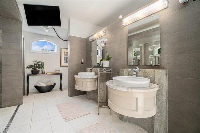 1634 Lenox Rd NE, Atlanta, GA 30306 - bathroom featuring tile patterned floors, tile walls, and a sink