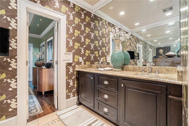 1634 Lenox Rd NE, Atlanta, GA 30306 - full bath with visible vents, a sink, crown molding, double vanity, and wallpapered walls