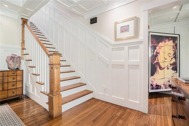 1634 Lenox Rd NE, Atlanta, GA 30306 - stairs featuring a decorative wall, coffered ceiling, wood finished floors, and visible vents