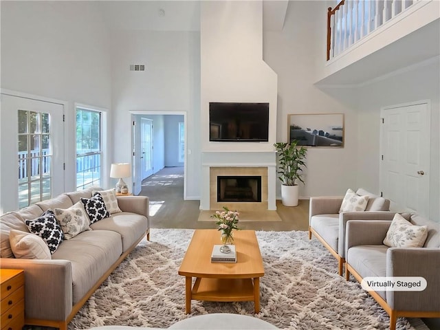 132 Lynnview Ct, Mcdonough, GA 30252 - living area featuring a high ceiling, baseboards, a fireplace with flush hearth, and wood finished floors
