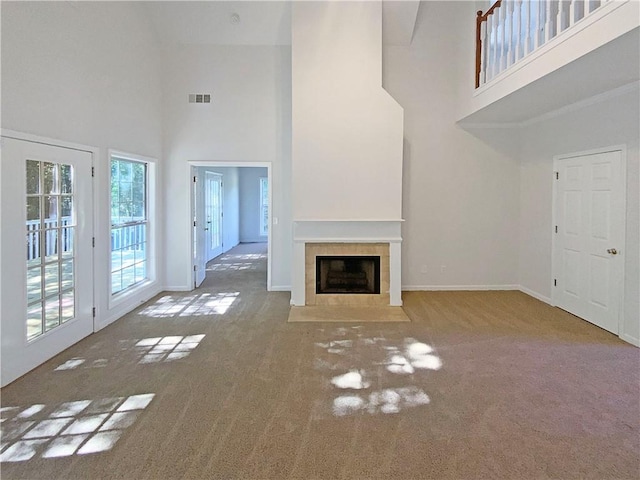 132 Lynnview Ct, Mcdonough, GA 30252 - unfurnished living room with a high ceiling, carpet, a tile fireplace, and baseboards