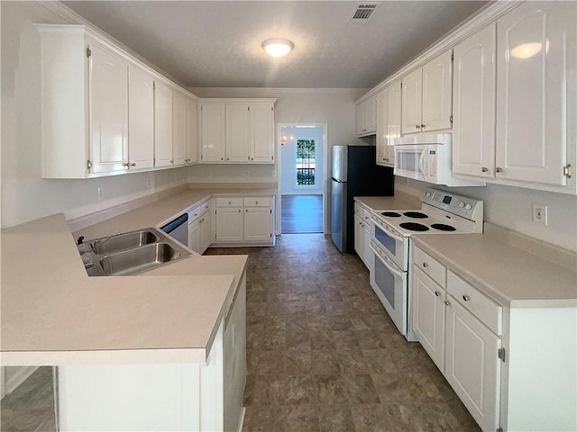 132 Lynnview Ct, Mcdonough, GA 30252 - kitchen with white appliances, a sink, white cabinets, a peninsula, and ornamental molding