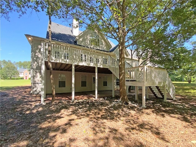 132 Lynnview Ct, Mcdonough, GA 30252 - rear view of property with stairs, a wooden deck, and a chimney