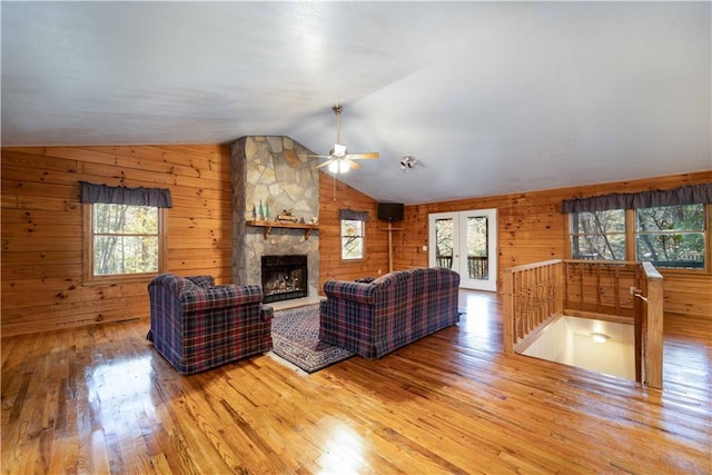 living room with hardwood / wood-style flooring, lofted ceiling, and a wealth of natural light