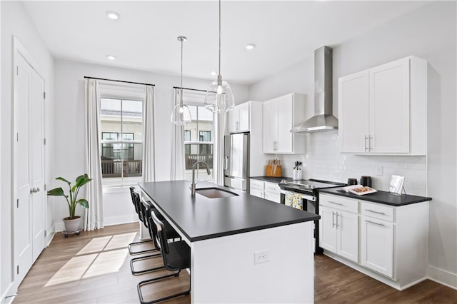 1247 Zucchini Cir SE, Atlanta, GA 30315 - kitchen with wall chimney range hood, a sink, appliances with stainless steel finishes, dark countertops, and dark wood-style floors