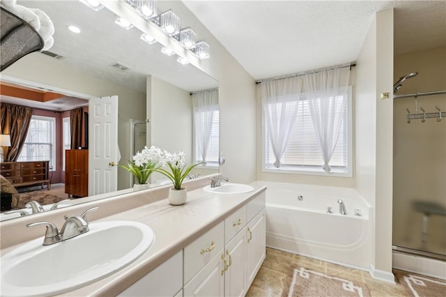 full bathroom featuring a sink, visible vents, a stall shower, and a bath