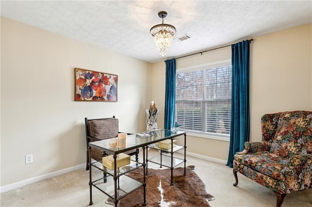 office space with baseboards, visible vents, a textured ceiling, carpet flooring, and a chandelier