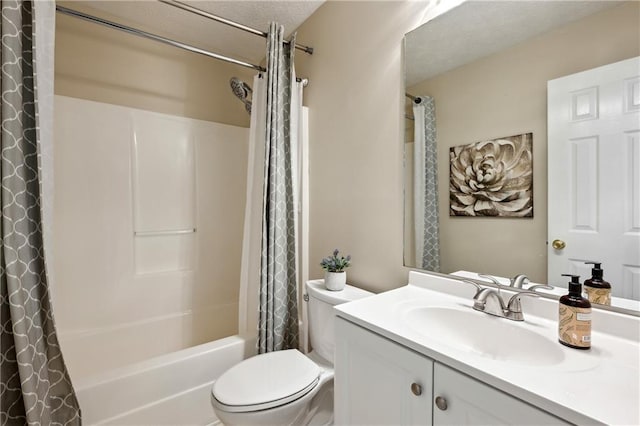 bathroom with vanity, toilet, shower / tub combo with curtain, and a textured ceiling