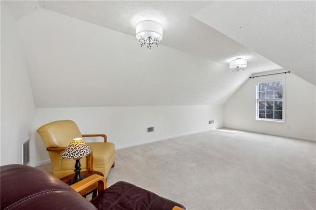 bonus room with visible vents, carpet floors, and a textured ceiling
