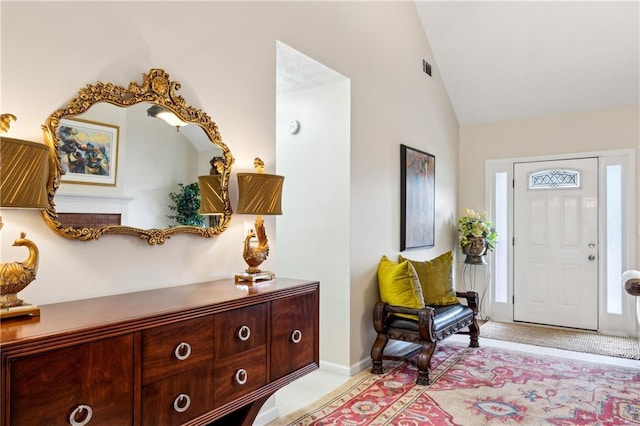 foyer featuring vaulted ceiling