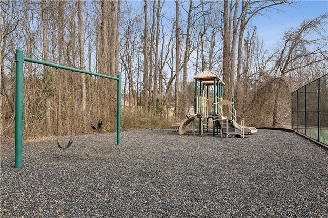 view of sport court with a playground