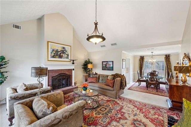 living room with a brick fireplace, a notable chandelier, and visible vents