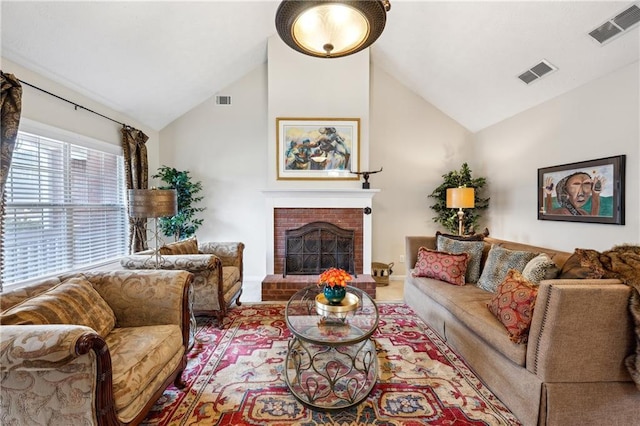 living room with high vaulted ceiling and a brick fireplace