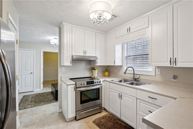 kitchen with a sink, under cabinet range hood, white cabinetry, appliances with stainless steel finishes, and an inviting chandelier