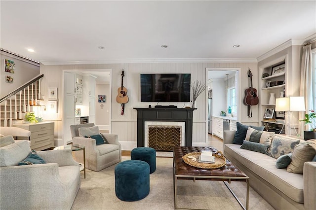 377 Camden Rd NE, Atlanta, GA 30309 - living room with crown molding, stairway, a decorative wall, and a fireplace