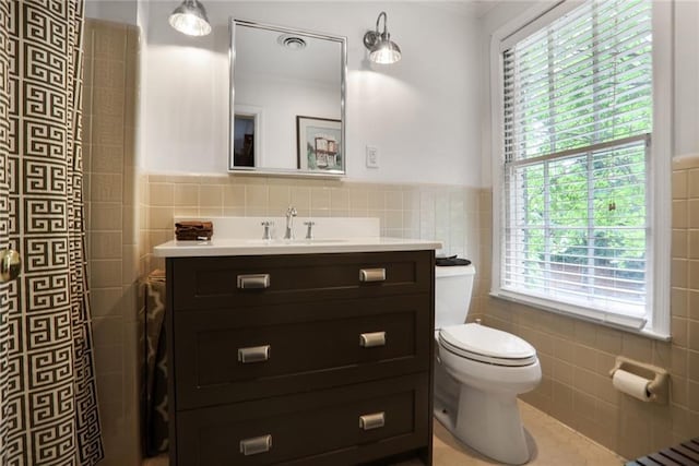 377 Camden Rd NE, Atlanta, GA 30309 - bathroom with tile walls, vanity, healthy amount of natural light, wainscoting, and tile patterned floors