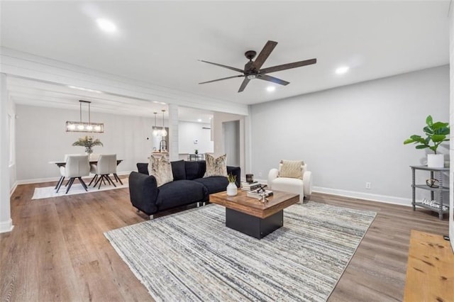 living room featuring recessed lighting, baseboards, wood finished floors, and ceiling fan