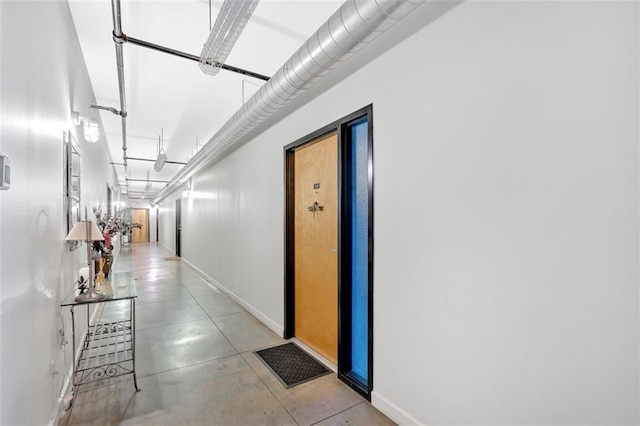 hall featuring light tile patterned floors