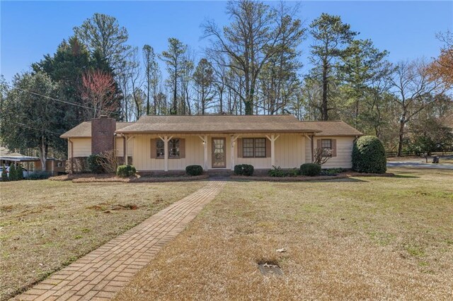 3439 Elm Creek Dr NW, Marietta, GA 30064 - ranch-style house featuring covered porch, a chimney, and a front yard