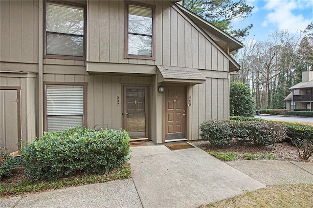 property entrance featuring board and batten siding