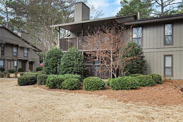 exterior space with a chimney and a balcony