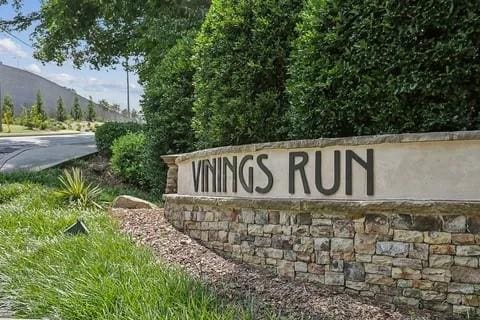 community / neighborhood sign with a mountain view