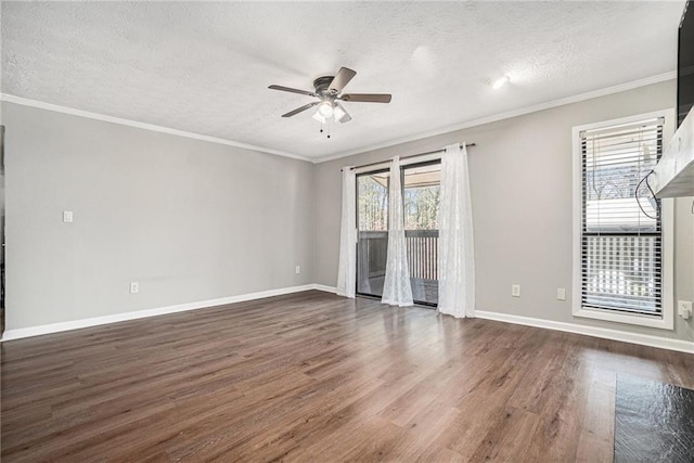 spare room with a textured ceiling, a healthy amount of sunlight, a ceiling fan, and dark wood finished floors
