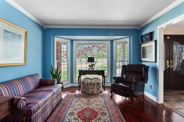 living area with dark hardwood / wood-style flooring and ornamental molding