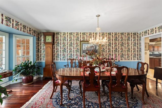 dining room featuring an inviting chandelier, dark hardwood / wood-style floors, and ornamental molding