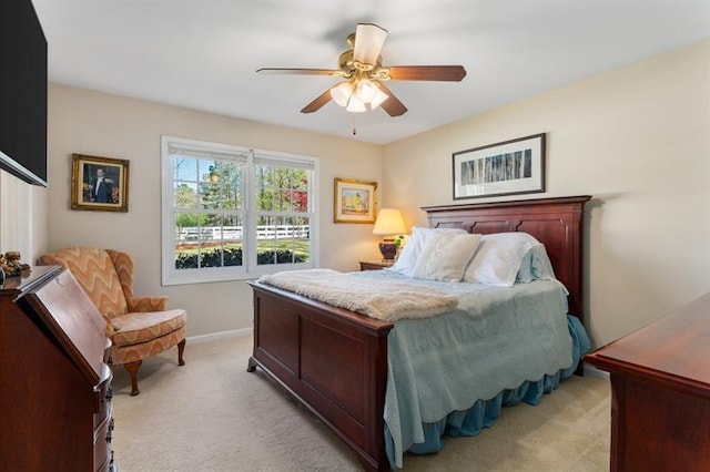 bedroom featuring ceiling fan and light carpet