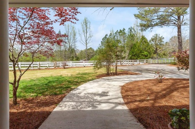 view of home's community featuring a lawn and a rural view